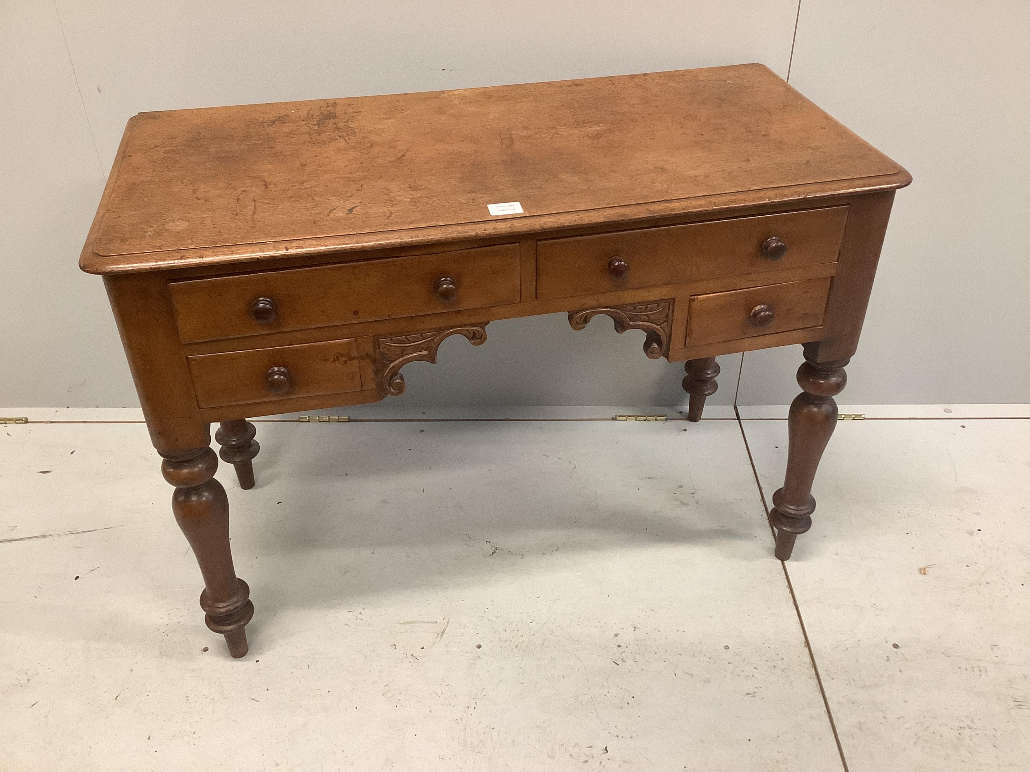 A Victorian mahogany kneehole dressing table, fitted four small drawers, width 101cm, depth 49cm, height 72cm. Condition - fair